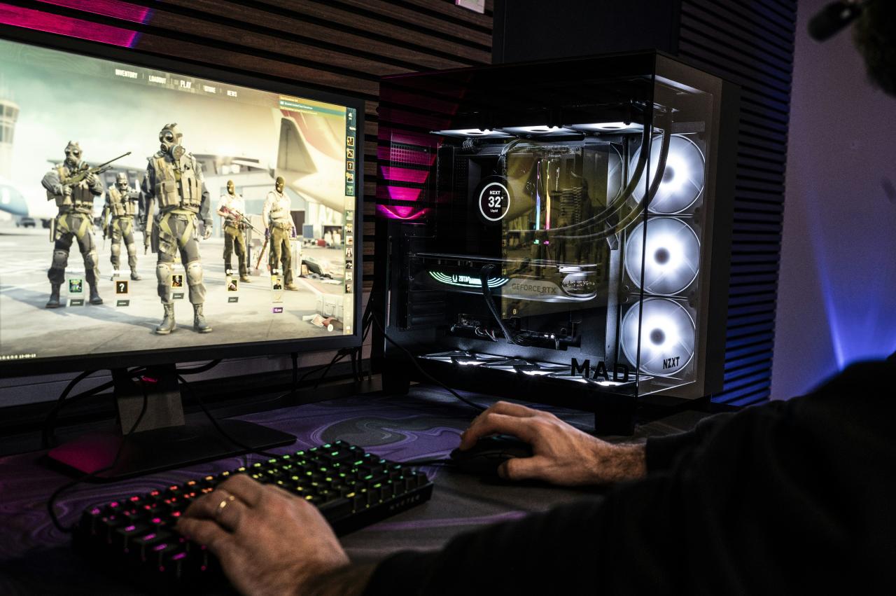 A man is playing a video game on his computer