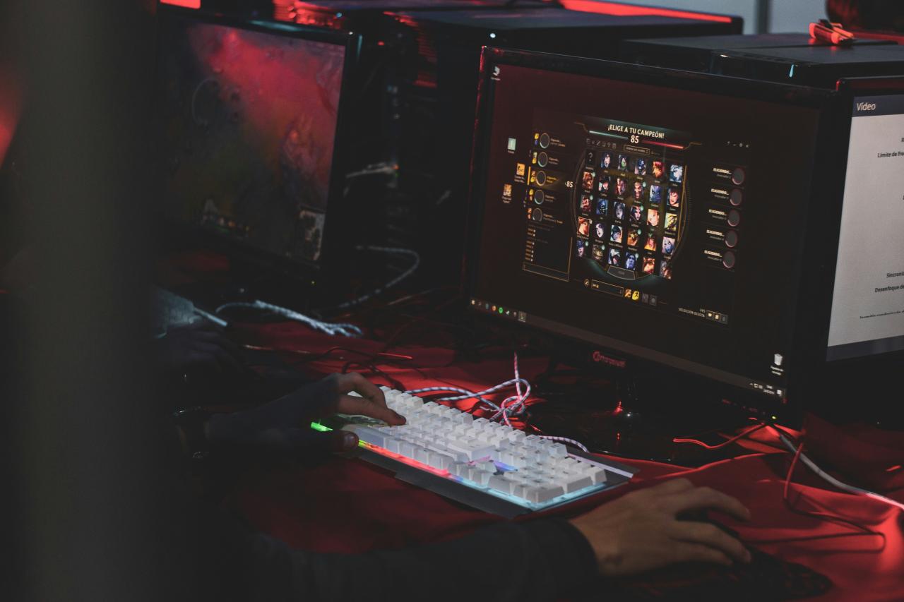 a person sitting at a desk with a keyboard and monitor