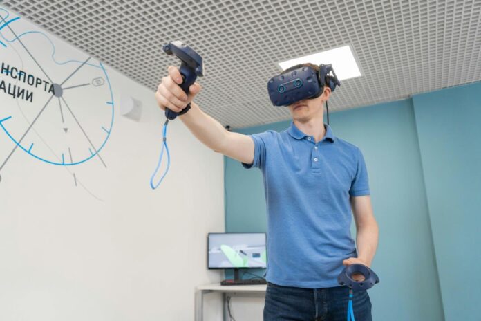 a man holding a video game controller in his hand